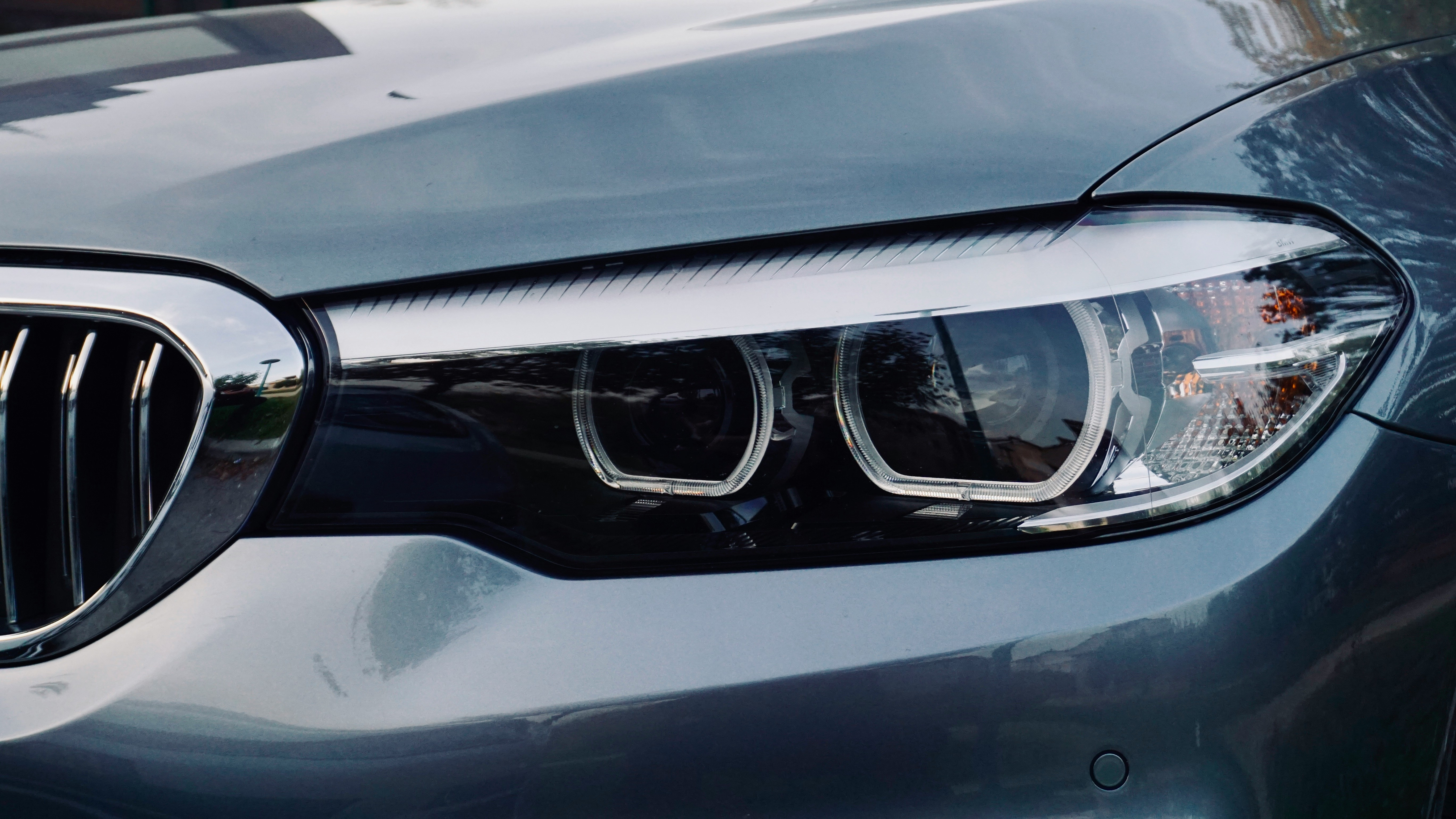 Technician inspecting a yellowed polycarbonate headlight lens