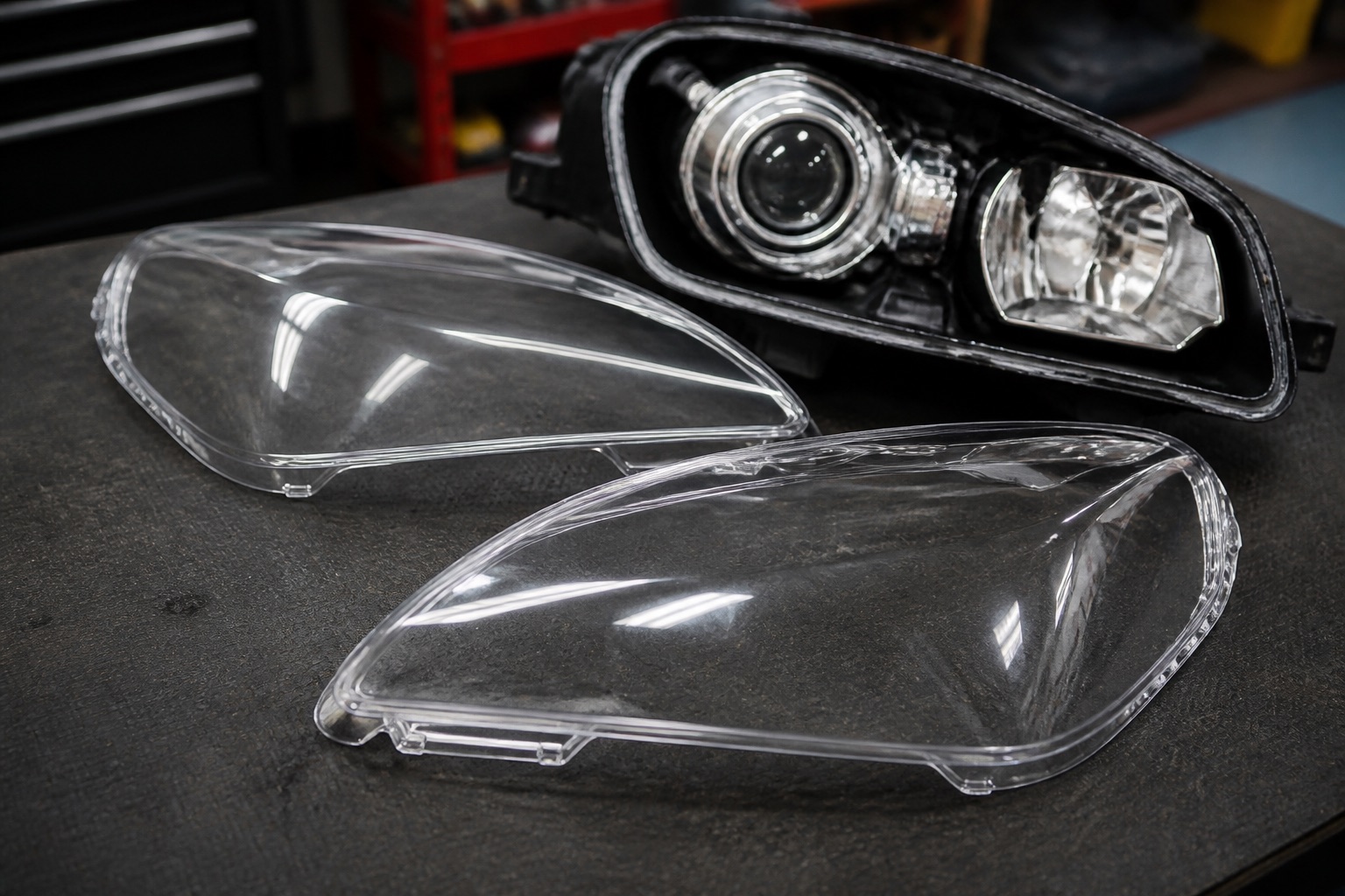 New clear polycarbonate headlight lens being fitted during replacement